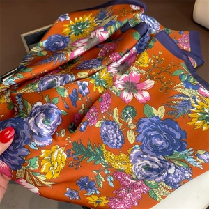 Detailed macro view showing the silky texture and floral print of the French square scarf