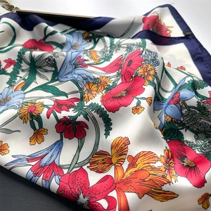 Elegant floral silk-feel square scarf with colorful lily print and navy blue borders