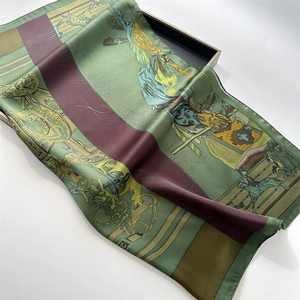 Vintage green silk-feel scarf with classical horse print on an elegant display tray