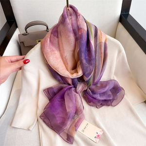 Elegant purple gradient silk scarf styled as a shawl with a premium soft texture drape