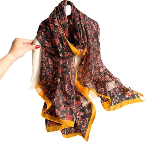 Elegant floral imitation silk scarf with pink flowers and yellow trim on dark base