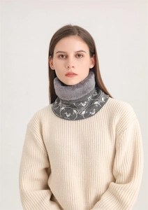 Close-up of winter neck warmer with gray faux fur and knit texture with bear pattern