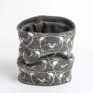 Detail of grey knitted winter neck warmer showing soft thick plush lining and bear pattern