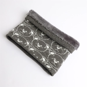 Detail of gray knitted neck warmer showing thick fleece lining and white bear pattern