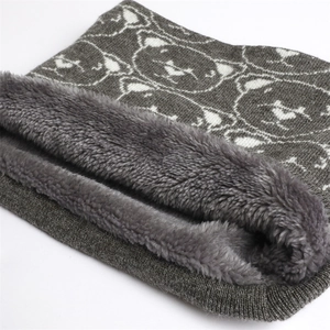 Detailed view of winter neck warmer with knit bear patterns and thick gray plush lining