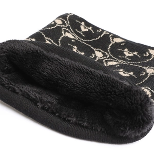 Close-up of winter knit neck warmer with black fleece lining and bear pattern