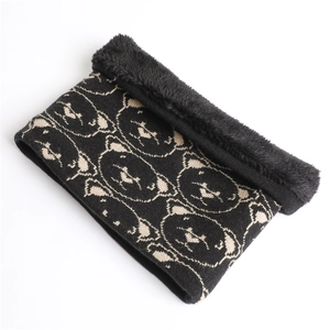 Detail of black knitted neck warmer with cute bear patterns and warm fleece lining