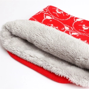 Close-up of red knitted winter scarf with polar bear pattern and thick grey fleece lining