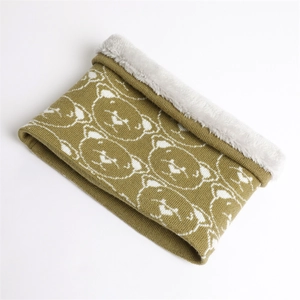 Detailed view of yellow knitted neck warmer with white bear patterns and plush lining