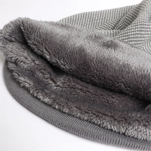 Macro shot of grey knitted beanie showing thick thermal fleece lining and neat stitching