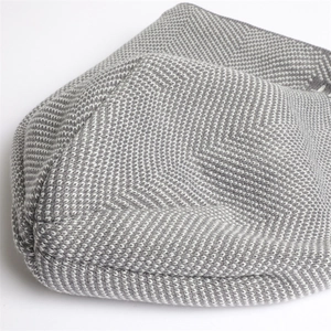 Close-up of grey and white chevron knit pattern showing thick thermal texture on beanie