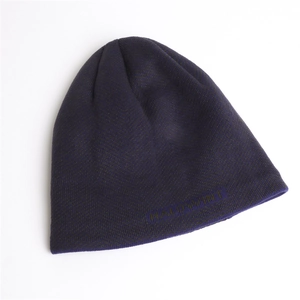 Detail of herringbone knit texture and woven logo on dark purple warm winter beanie