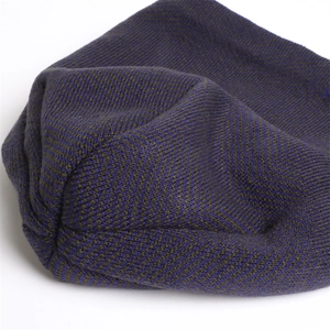 Detailed macro view of dual-color purple and olive green herringbone knit fabric texture