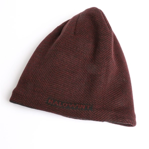 Detailed view of the red and black chevron knit pattern and HALOWINT embroidery on beanie