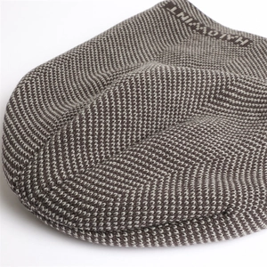 Close-up of brown and beige herringbone knit texture with HALLOWINT side lettering