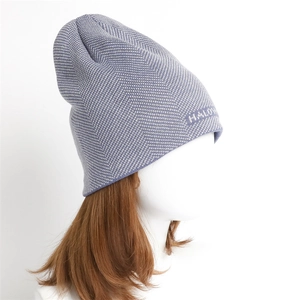 Detail of blue herringbone knit beanie featuring white HALO text logo on the side