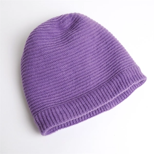 Close-up of purple ribbed knit beanie showing dense texture and winter fabric detail