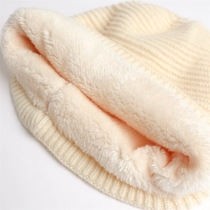 Detail of ribbed knit texture and soft thickened faux fleece lining of the warm winter beanie