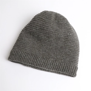 Detail of gray knitted beanie showing horizontal ribbing and wide windproof folded brim