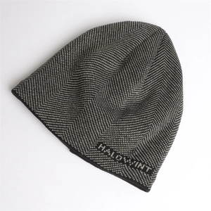 Detail of herringbone knit beanie featuring HALLOWINT embroidery and thick texture
