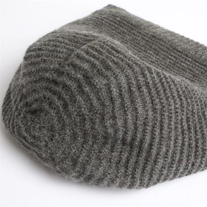 Detail of dark grey knit beanie featuring ribbed texture and soft brushed wool finish
