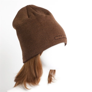 Detailed view of brown herringbone knit beanie featuring woven HALLOWEEN text pattern