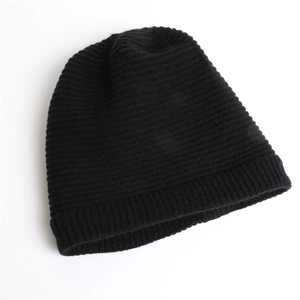 Detail of pure black knitted beanie featuring fine horizontal stripes and ribbed texture