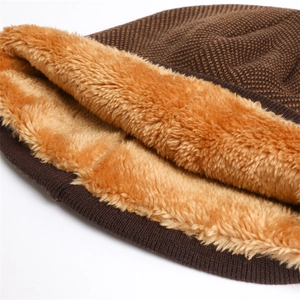 Detail of dark brown knitted hat with thick yellow fleece lining for winter warmth