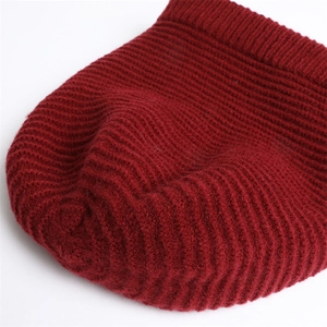 Close-up of deep red ribbed knit beanie showing thick warm texture and weave detail