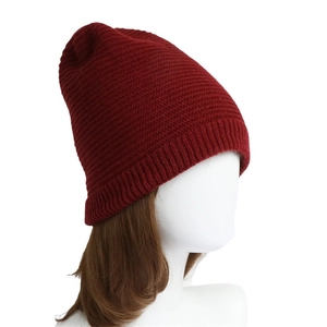 Deep red ribbed knit beanie for winter featuring a thick texture and slouchy design