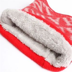 Close-up of red and pink knit texture with thick grey fleece lining for warmth