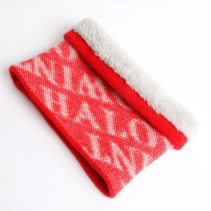 Detail of red and cream knit scarf with warm fleece lining and geometric pattern