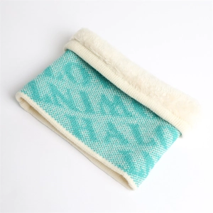 Detail of turquoise knit snood with white fleece lining and wavy pattern texture