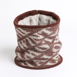 Close-up of knit neck warmer showing brown geometric pattern and thick grey plush lining
