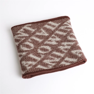 Detailed view of knitted winter neck warmer with brown and beige jacquard patterns