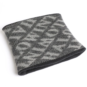 Detail of gray and black geometric knit neck gaiter showing thick diamond stitch texture