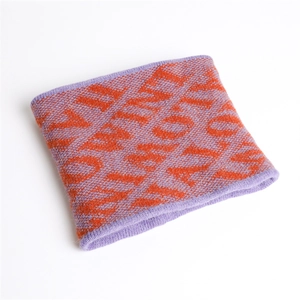 Detail view of purple and orange letter jacquard knit neck warmer with soft thick texture