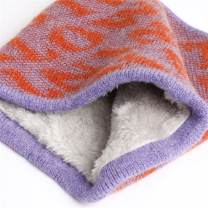 Detail of warm winter knit scarf with orange animal print and thick plush faux fur lining