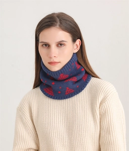 Close-up of navy knit neck warmer featuring red Christmas tree patterns and ribbed edges