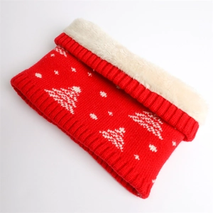 Close-up of red knit neck warmer with white Christmas tree pattern and soft faux fur lining