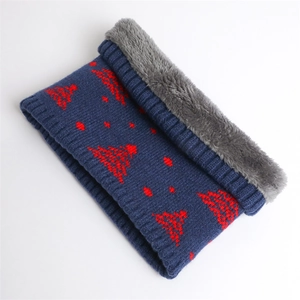 Detail of dark blue knit snood with red tree pattern and thick grey fleece lining