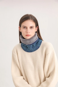 Detail of warm winter knit neck warmer with faux fur lining and mixed blue-green texture