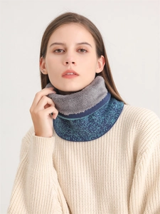 Detail of blue-green knit neck warmer with thick grey faux fleece lining for winter