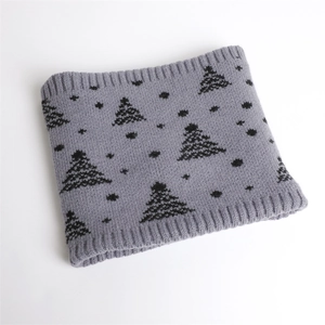 Detail of grey knitted neck warmer featuring black Christmas tree pattern and ribbed edges