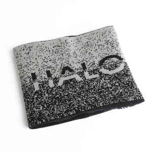 Close-up of thick knit neck warmer featuring black and grey gradient and HALO knit lettering