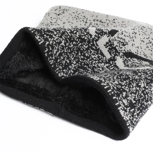 Close-up of knit winter neck warmer with thick black plush lining and grey flecked exterior