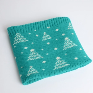 Macro view of blue knitted winter neck gaiter with white jacquard Christmas tree patterns