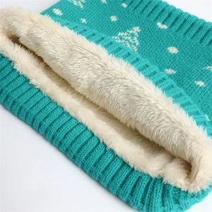 Detail shot of the thick white fleece lining and teal knitted pattern of the warm neck warmer