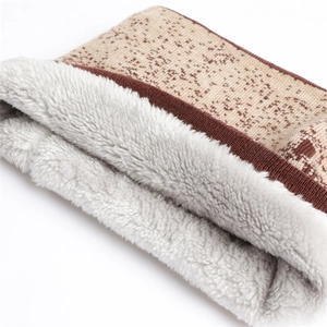 Close-up of thick gradient knit scarf with warm faux lamb wool lining and vintage pattern