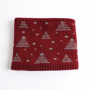 Detailed knit texture of dark red winter neck warmer with gray Christmas tree patterns